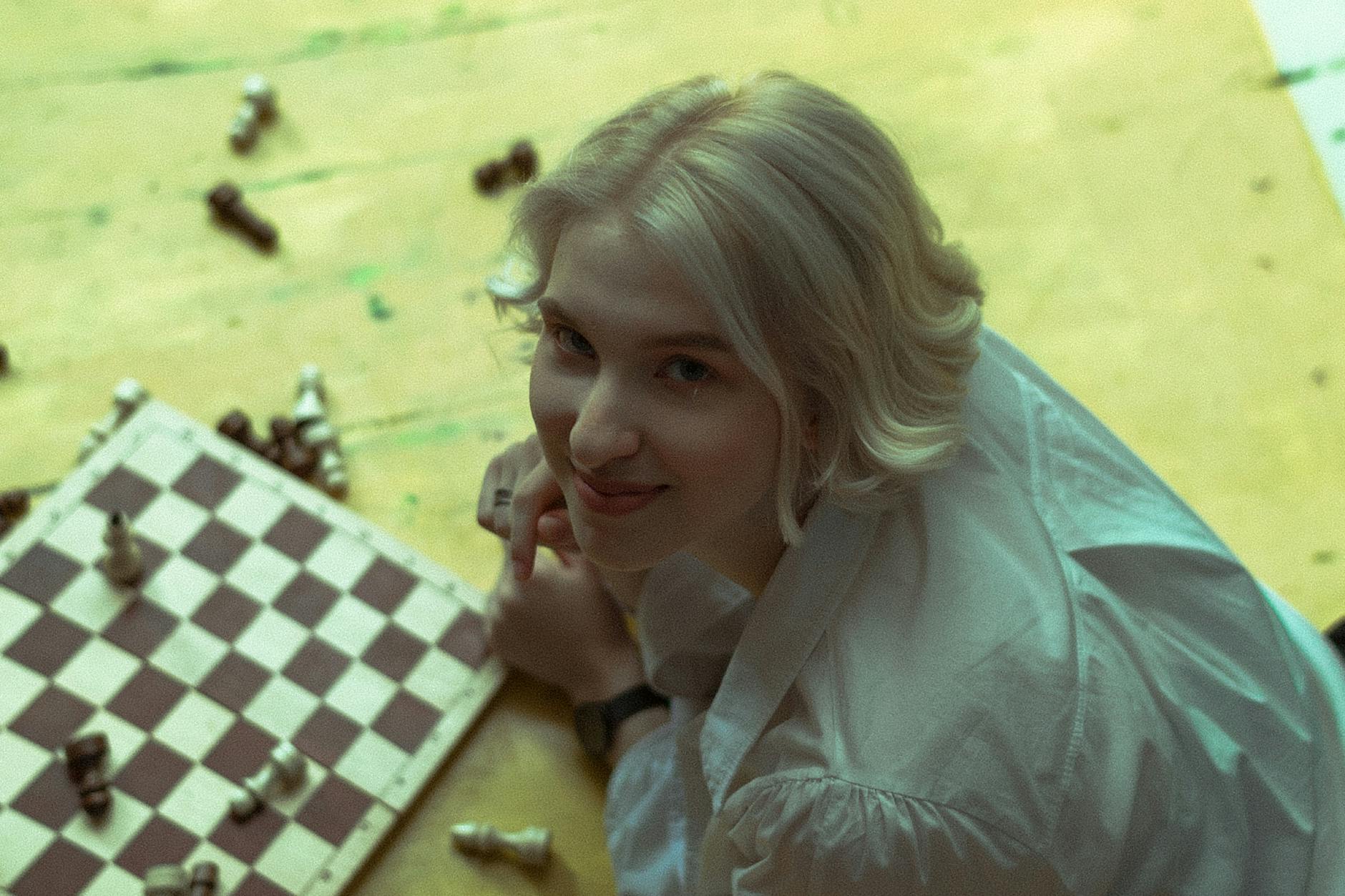 blonde woman playing chess